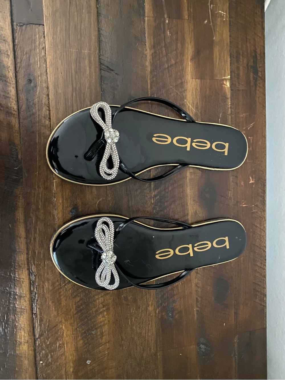 bebe Black Patent Thong Sandals with Crystal Bow Accent